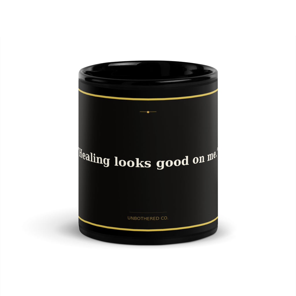 Black 11oz self-care affirmation mug with gold text reading Healing Looks Good On Me - Unbothered Co.