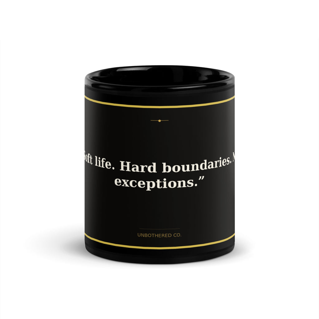 Black 11oz ceramic affirmation mug with gold text reading Hard Boundaries - Unbothered Co.